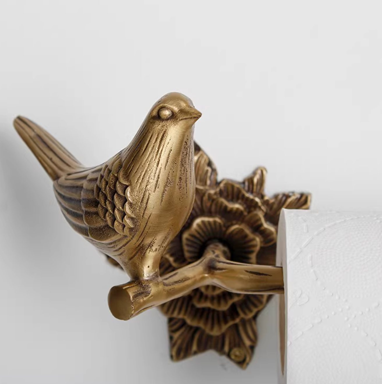 Brass bird toilet paper holder and towel racks with floral details, home decor accent.
